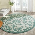 Handmade Avant-garde Floral Scrolls Ivory/ Blue Rug (7' Round)