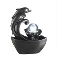 The Delfini Tabletop Dolphin Water Fountain With Led Light and Glass Sphere