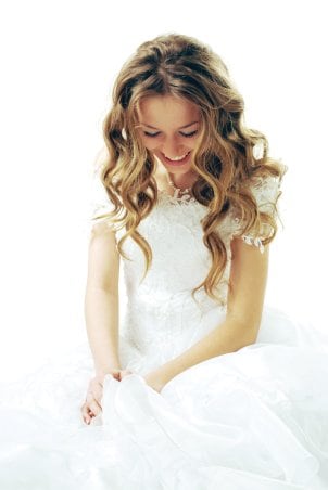 A beautiful modern bride looking down at her wedding band