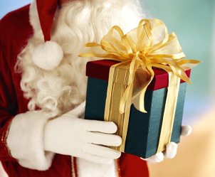 Santa holding a Christmas gift
