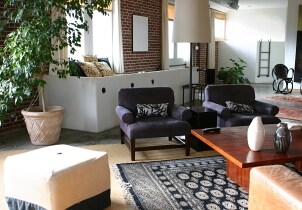 Area rugs designate two sitting areas in this room