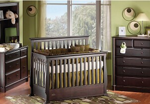 Baby crib in a green and brown nursery