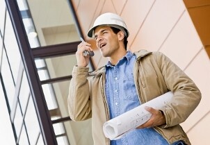 Construction worker uses a two-way radio