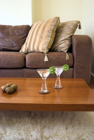 Wooden cocktail table with two kiwi martinis on top