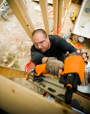 Man driving nails with an air tool