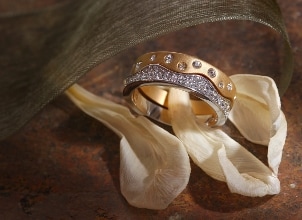 Two pretty diamond band-style rings, one in yellow gold and one in white gold