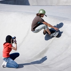 Female photographer taking photos of a skateboarder