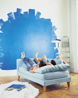 Couple painting a wall for home improvement