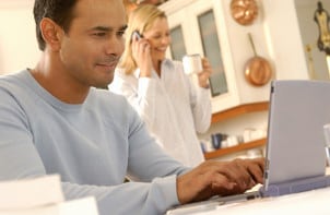 Man typing on a netbook computer