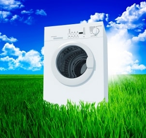 Environmentally friendly clothes washer in a green grassy field