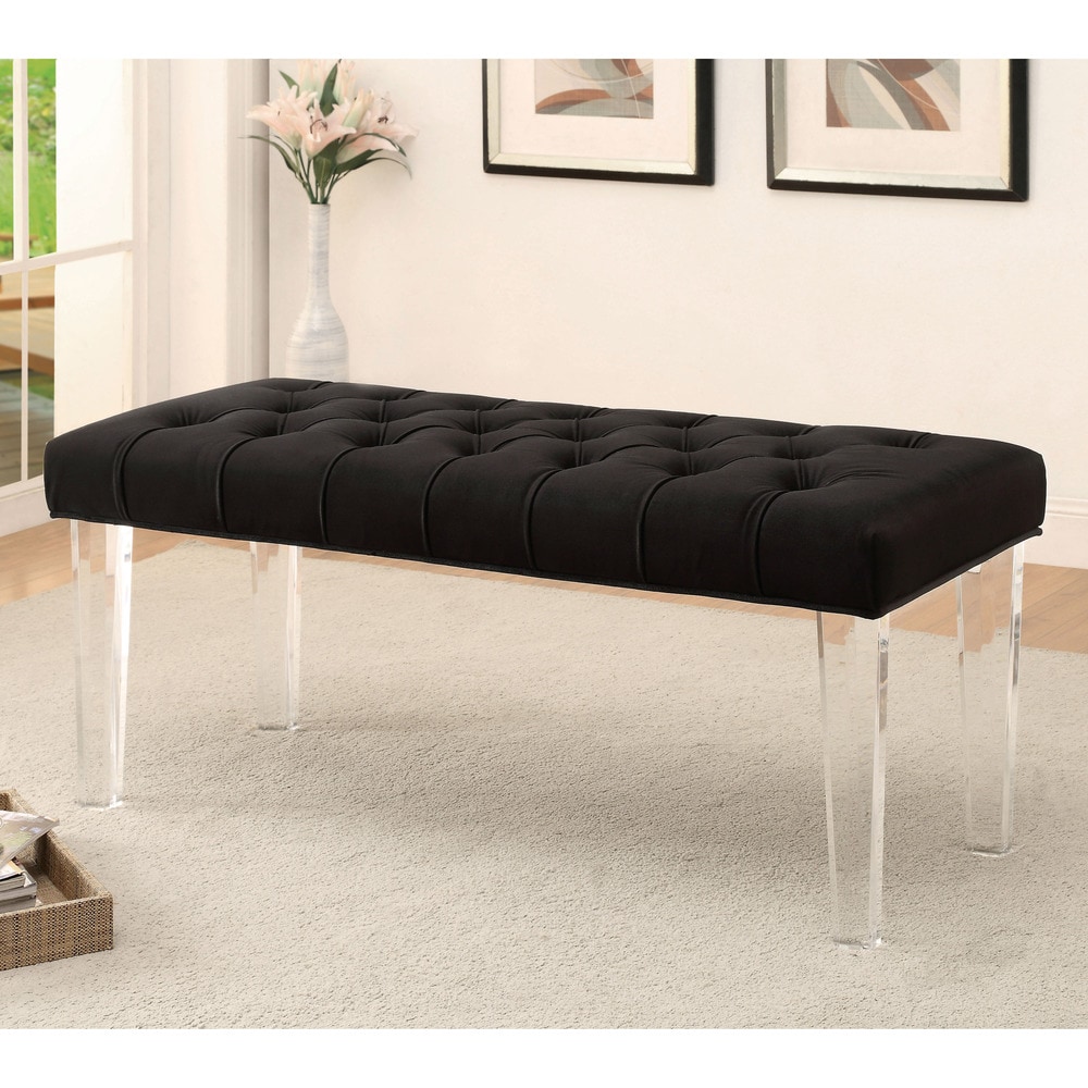 A long upholstered bench with tufted brown fabric and clear acrylic legs placed in a living room.