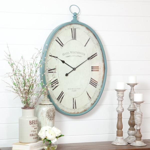Sonia Blue Metal Oval Wall Clock - 37.5"H x 23.5"W x 2.5"D. Opens flyout.