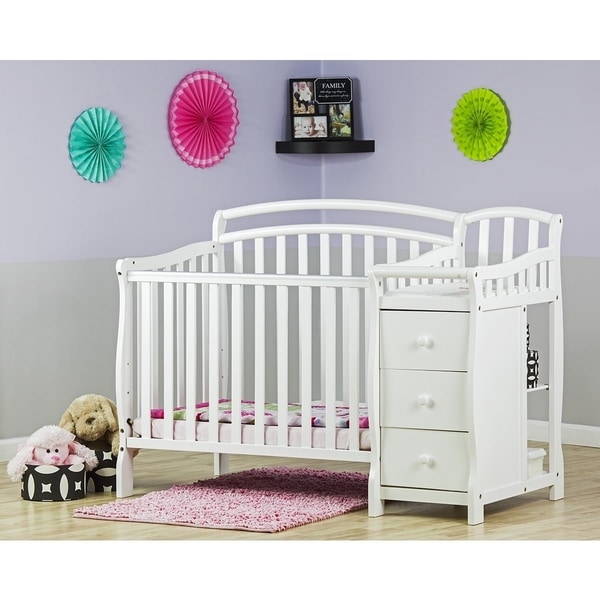 pink crib with changing table