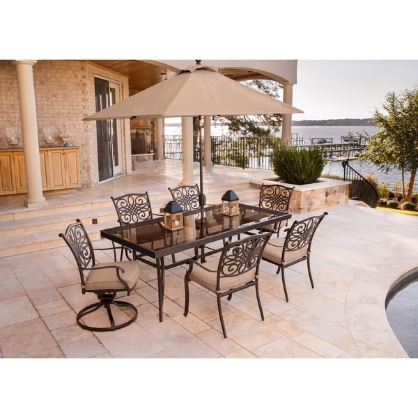Hanover Traditions 7-Piece Dining Set in Tan with Extra Large Glass-Top Dining Table, 9 Ft. Table Umbrella, and Umbrella Stand