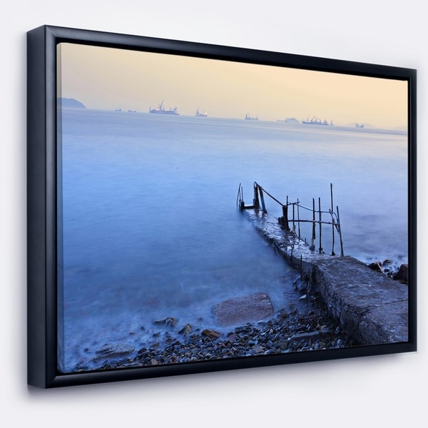 Designart 'Abandoned Pier into Blue Sea' Sea Bridge Framed Canvas Art Print