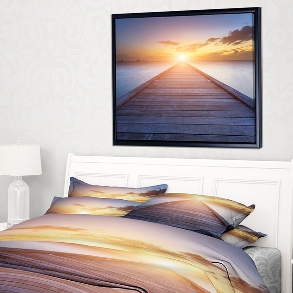 Designart 'Wooden Pier to Bright Evening Sun' Sea Bridge Framed Canvas Art Print