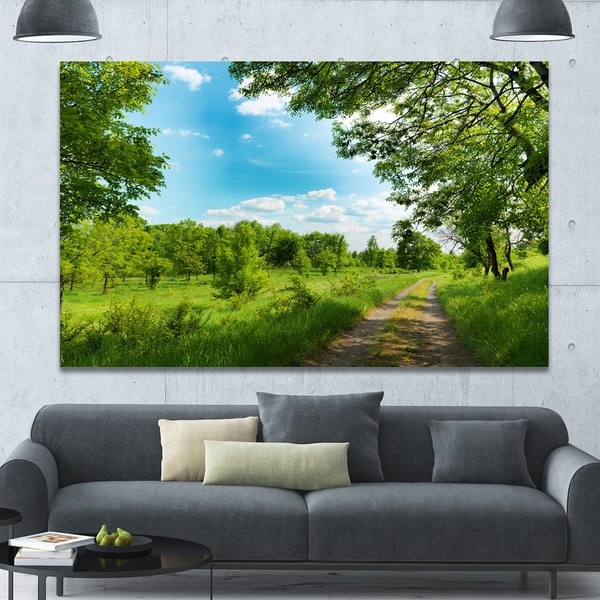 Designart 'Green Forest Road and Blue Sky' Modern Landscape Canvas Art