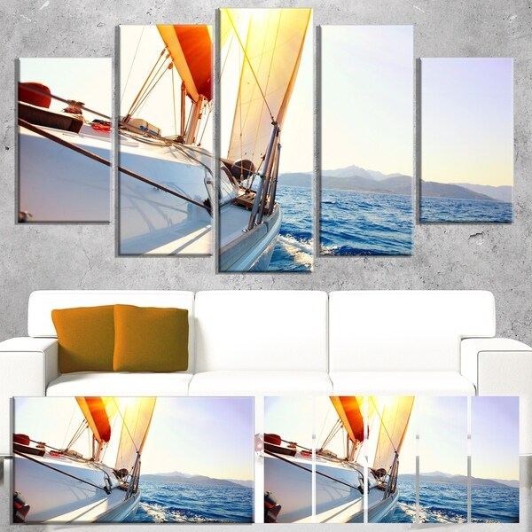 Designart 'Sailboat Sailing in the Blue Sea' Large Seashore Canvas Wall Art