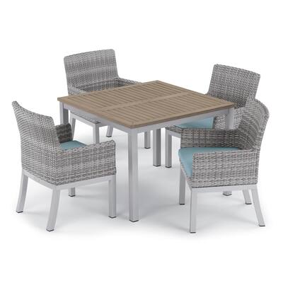 Oxford Garden Travira 5-piece 39-inch Tekwood Vintage Dining Table & Argento Resin Wicker Armchair Set - Ice Blue Cushions