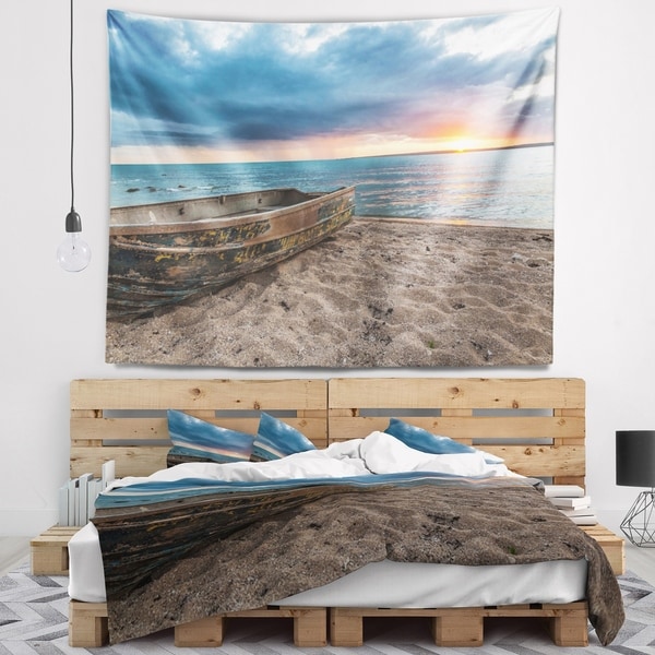 Designart 'Rusty Row Boat on Sand at Sunset' Seascape Wall Tapestry