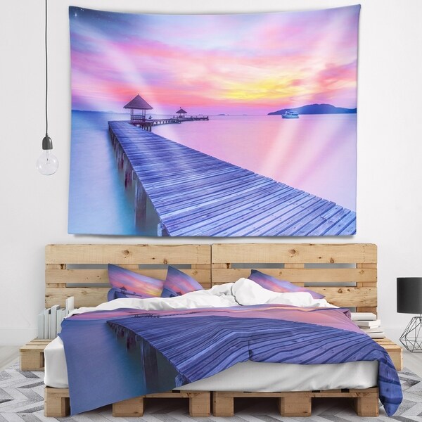 Designart 'Purple Tinged Wood Bridge and Beach' Pier Seascape Wall Tapestry