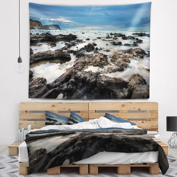 Designart 'Rocky Seashore with Blue Sky Over' Seashore Wall Tapestry