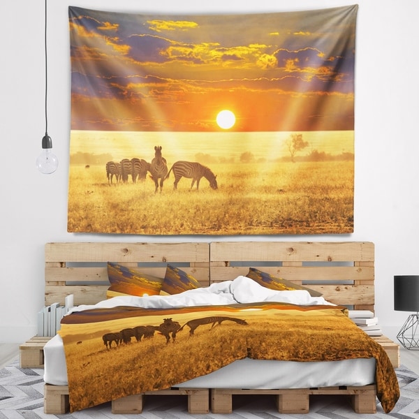 Designart 'Group of Zebras Grazing At Sunset' Animal Wall Tapestry