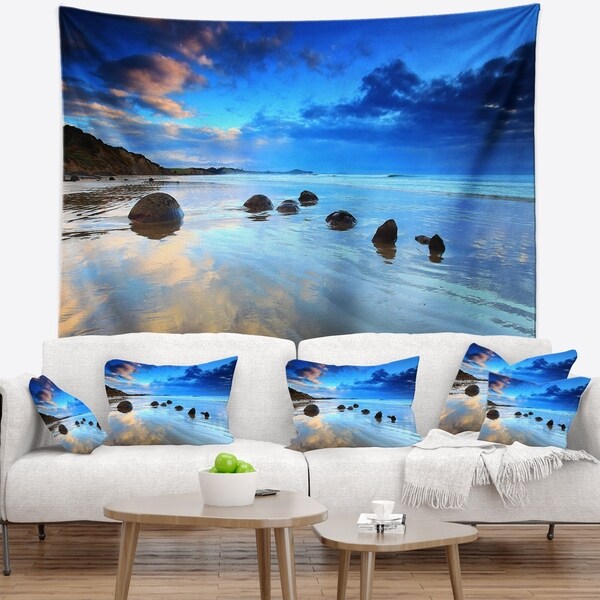 Designart 'Moeraki Boulders Under Cloudy Sky' Seashore Photo Wall Tapestry