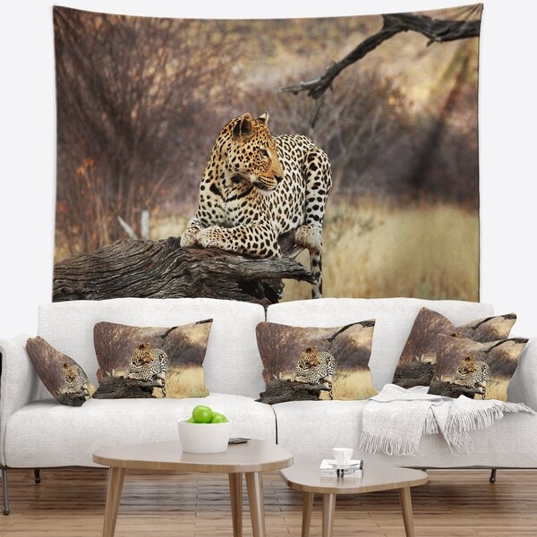 Designart 'Leopard Sitting on Tree Trunk' African Wall Tapestry