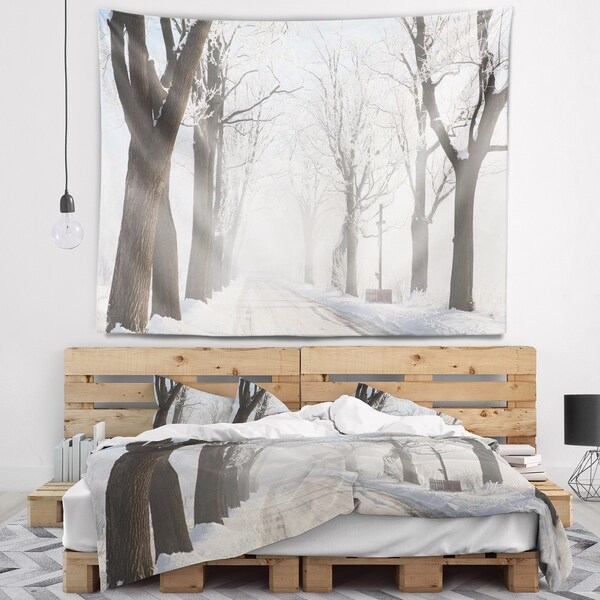 Designart 'Misty Rural Road in Winter Forest' Forest Wall Tapestry