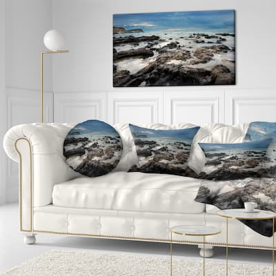 Designart 'Rocky Seashore with Blue Sky Over' Seashore Throw Pillow