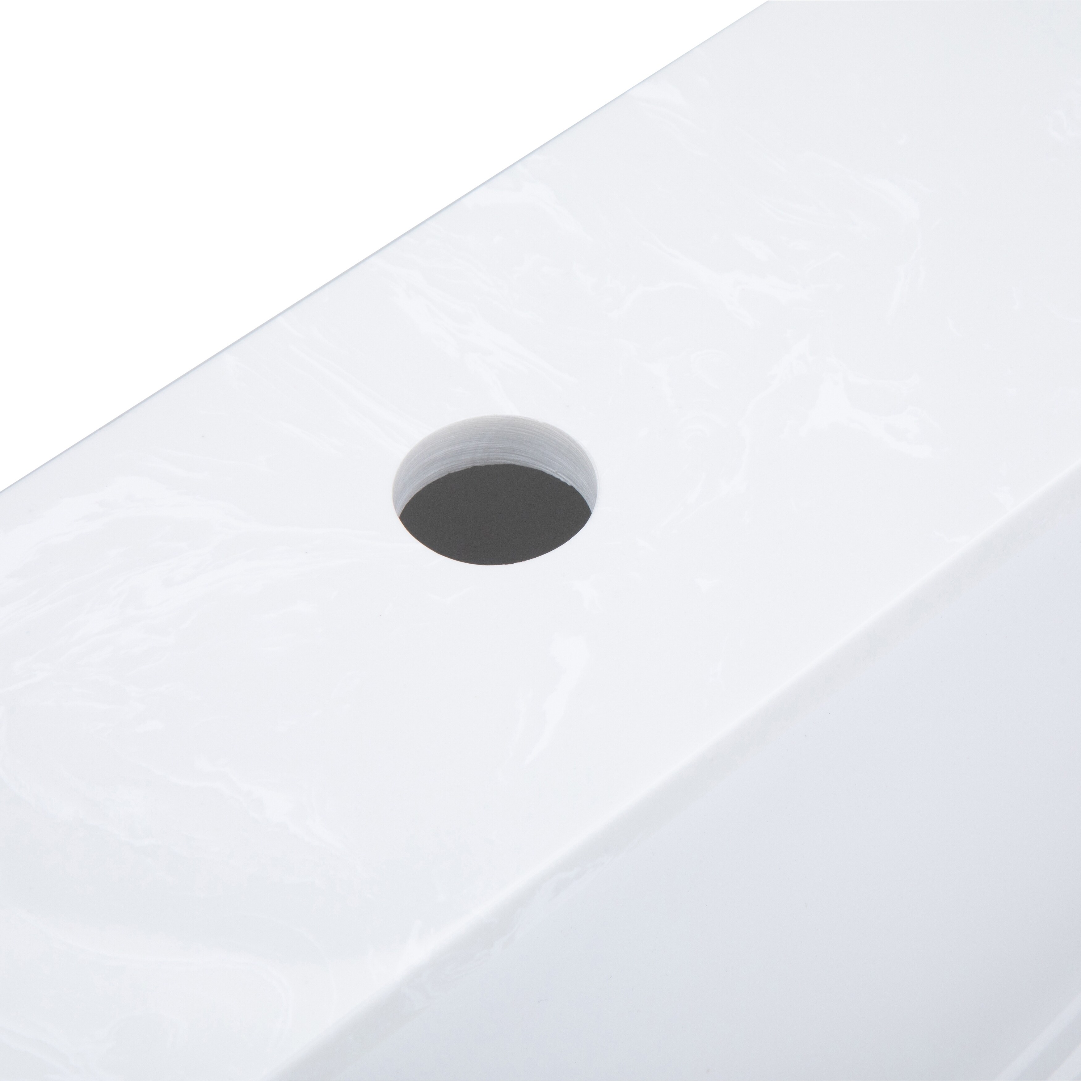 Close-up of the white marble countertop surface with a circular cutout.