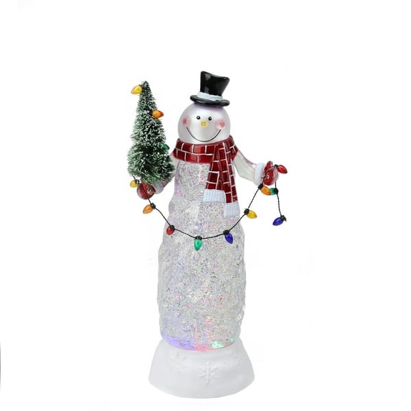 A smiling snowman towers over laughing children building a mini