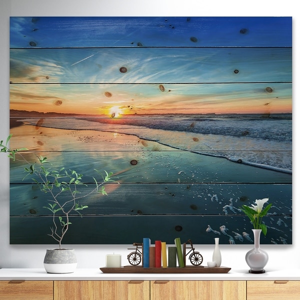 Designart 'Blue Seashore with Distant Sunset' Seascape Print on Natural Pine Wood - Blue