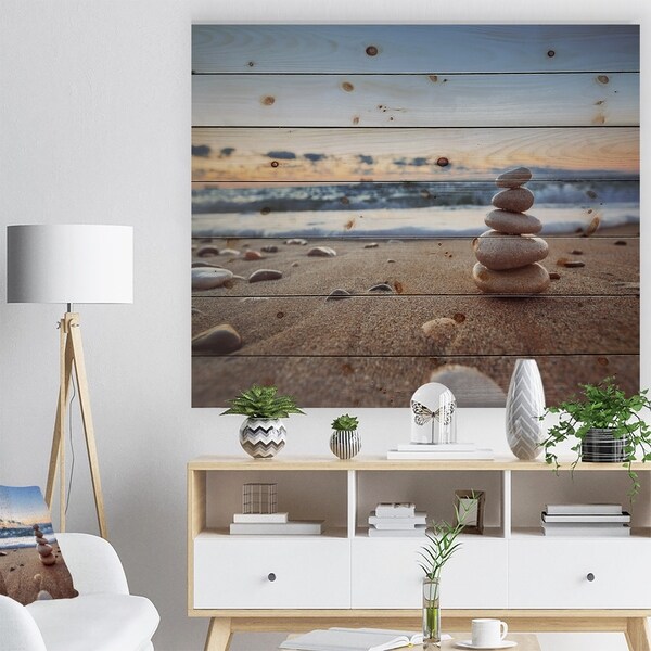 Designart 'Stones Balance on Sandy Beach' Seashore Print on Natural Pine Wood - Brown