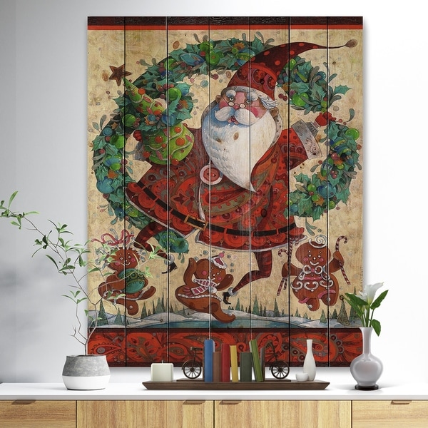 Designart 'Frolic Santa with Gingerbread Men and Wreathe' Print on Natural Pine Wood - Red