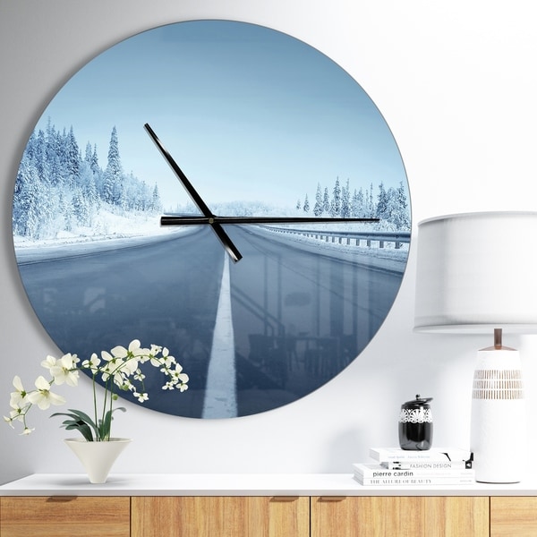 Designart 'Road in winter forest' Oversized Landscapes Wall CLock