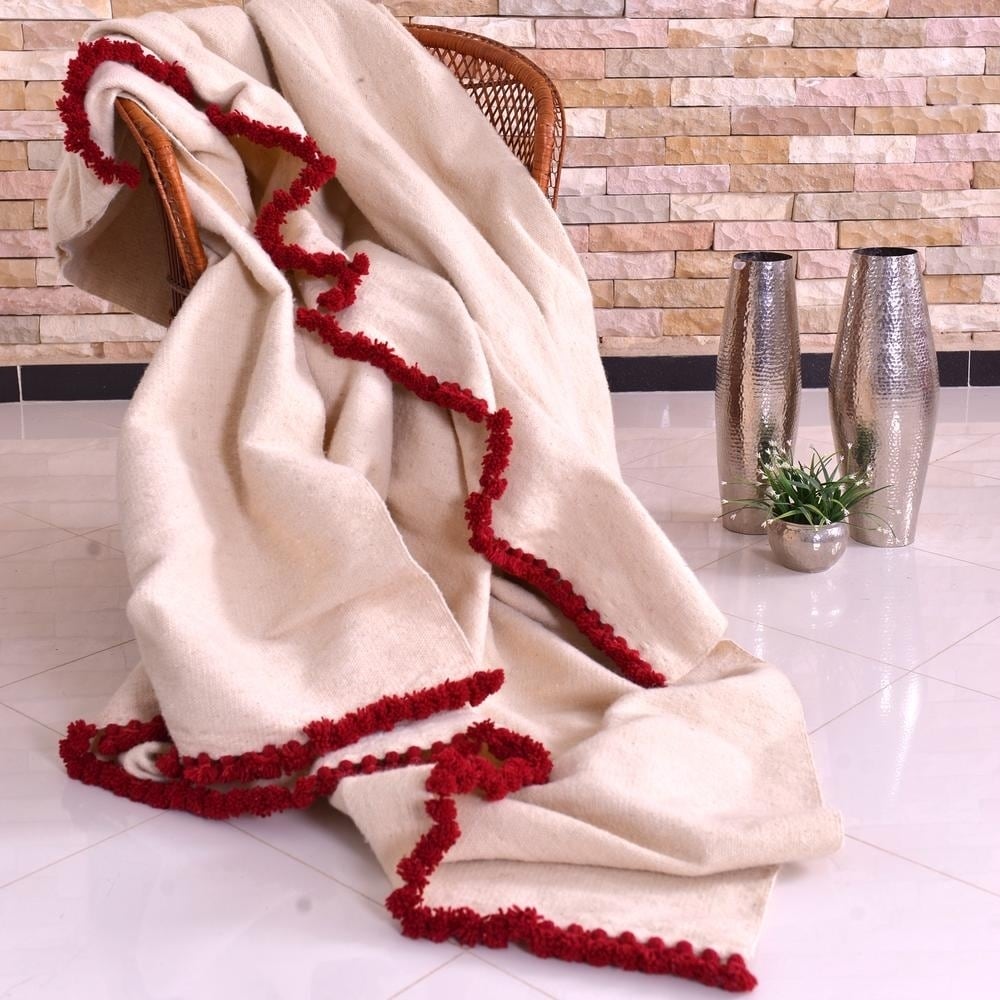 Hand woven Wool Pom Pom Blanket Off White with Chili Red Bed