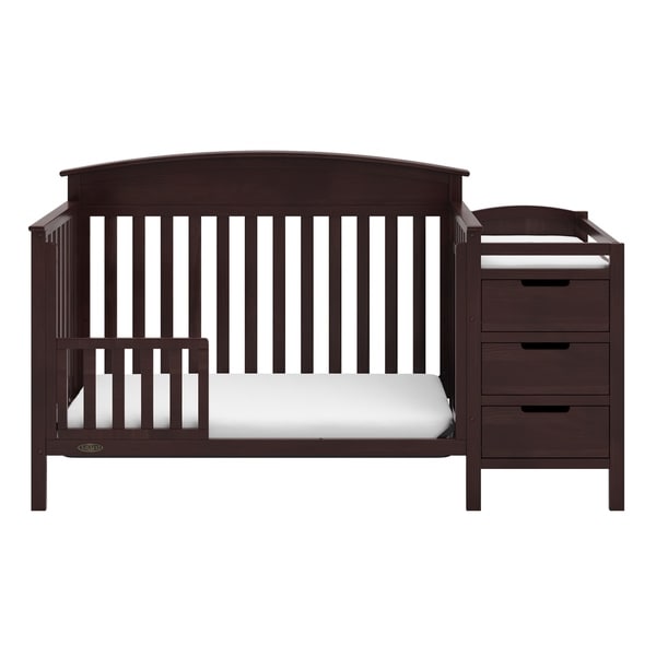 brown crib with changing table