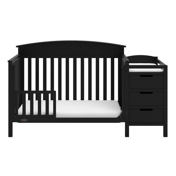 white crib with changing table attached