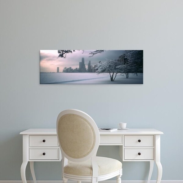 Easy Art Prints Panoramic Images's 'Snow covered tree on beach with a city, North Avenue Beach, Chicago, Illinois' Canvas Art