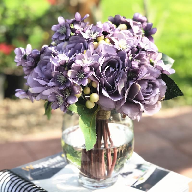 Enova Home Artificial Purple Silk Roses and Mixed Fake Flowers Arrangement in Clear Round Glass Vase with Faux Water