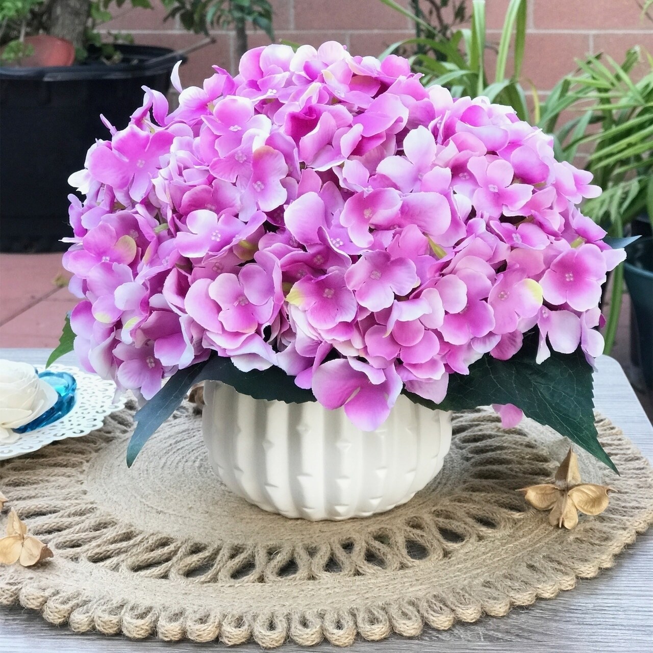 purple artificial flowers in vase