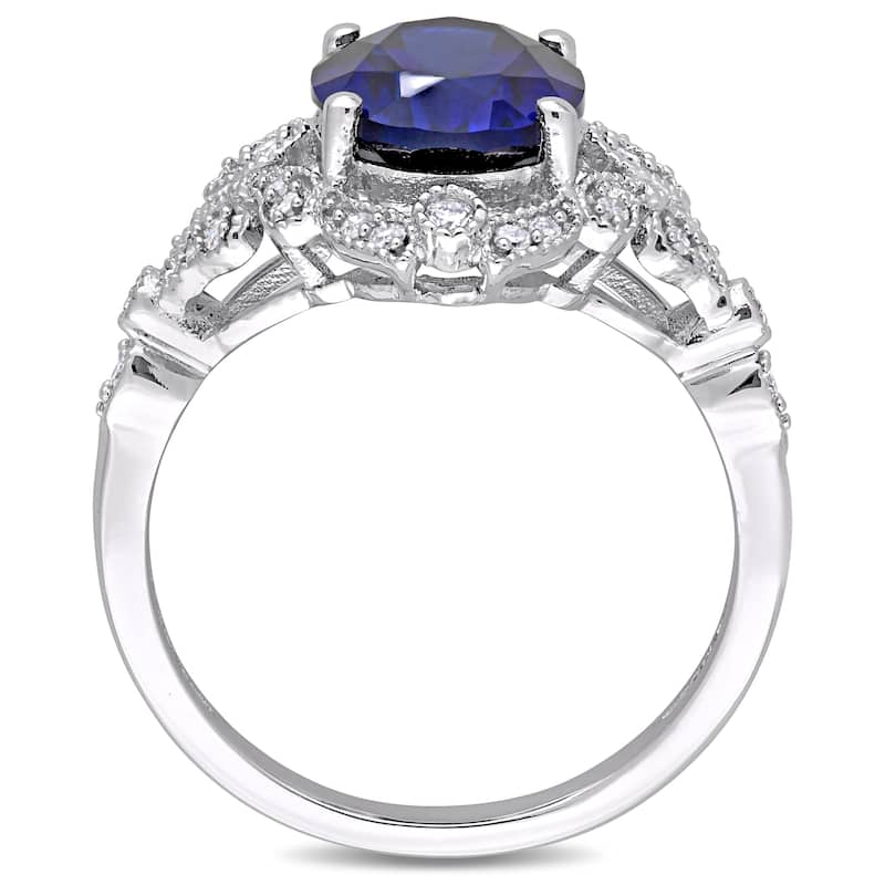 Miadora 10k White Gold Created Blue Sapphire and 1/5ct TDW Diamond Vintage Halo Cocktail Ring