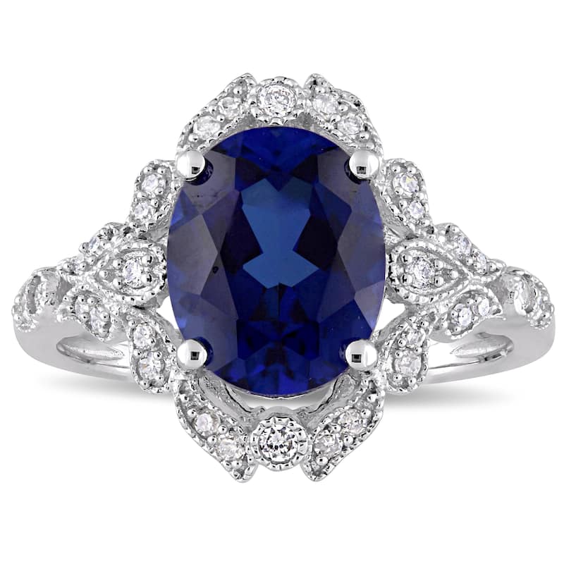 Miadora 10k White Gold Created Blue Sapphire and 1/5ct TDW Diamond Vintage Halo Cocktail Ring