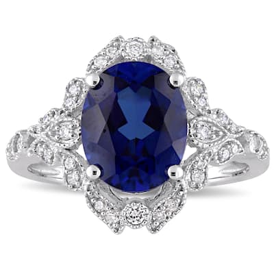 Miadora 10k White Gold Created Blue Sapphire and 1/5ct TDW Diamond Vintage Halo Cocktail Ring