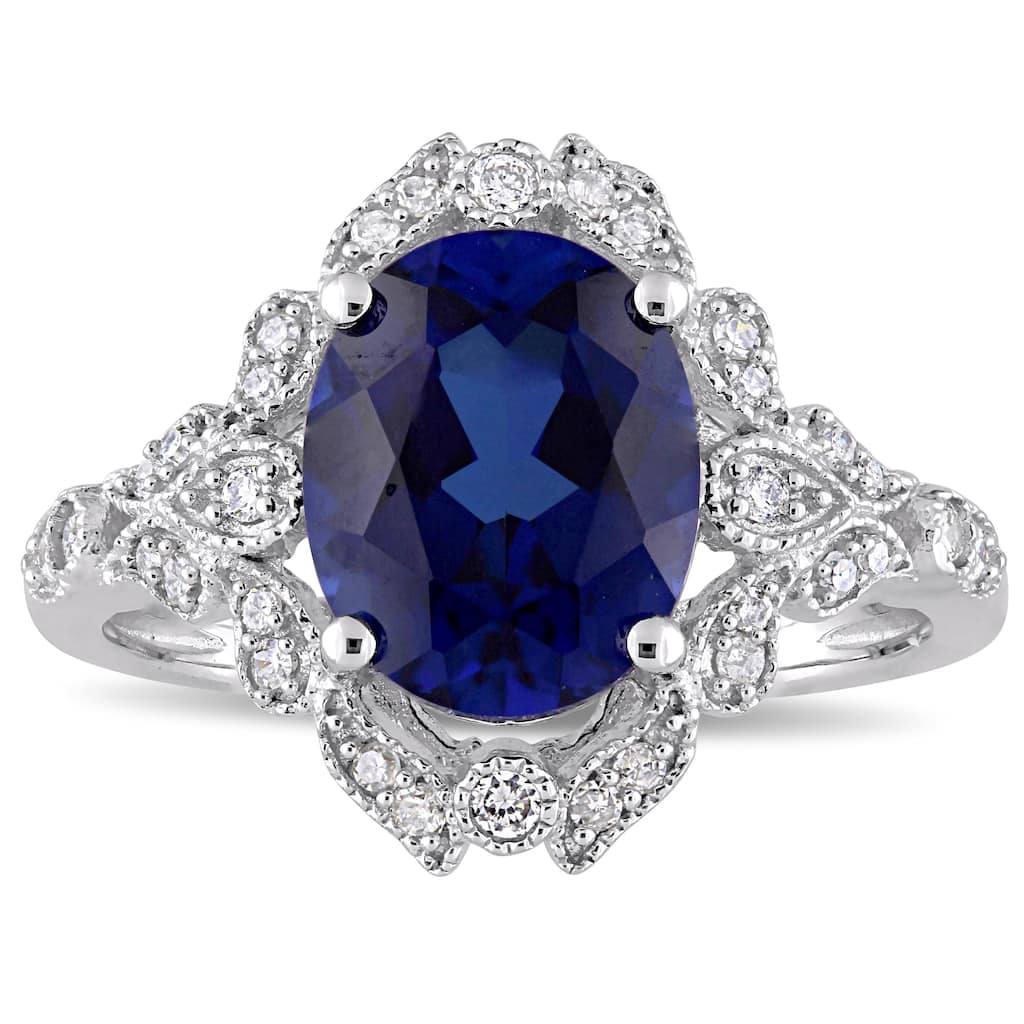 Miadora 10k White Gold Created Blue Sapphire and 1/5ct TDW Diamond Vintage Halo Cocktail Ring