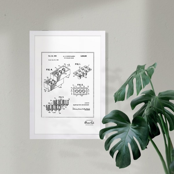 Wynwood Studio 'Lego toy building brick 1961, Silver Metallic' Symbols and Objects Framed Wall Art Print - Gray, White - 13 x 19