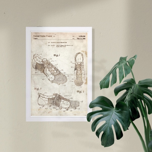 Wynwood Studio 'Training shoe for soccer 1980 Parchment' Sports and Teams Framed Wall Art Print - Brown, White - 13 x 19