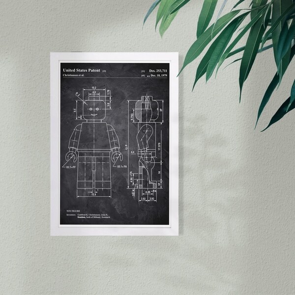 Wynwood Studio 'Lego Toy Figure 1979 Chalkboard' Entertainment and Hobbies Framed Wall Art Print - Black, White - 13 x 19